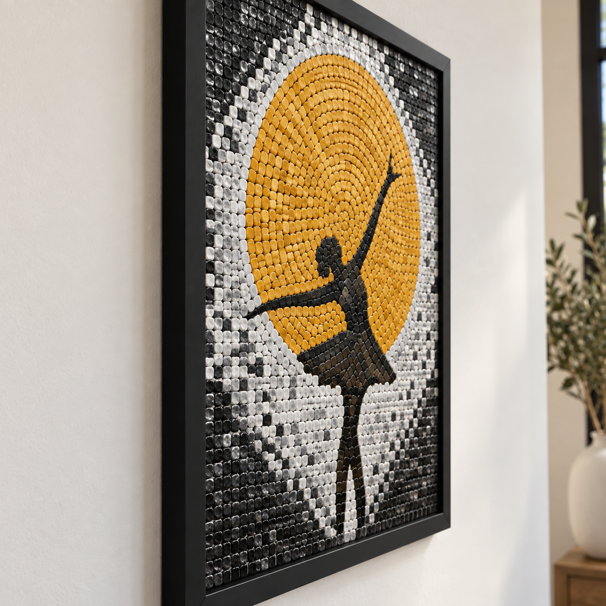Close-up framed mosaic panel featuring dancer silhouette against golden sun circle