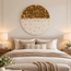 Round stone mosaic wall art with gold top half and scattered tiny gold accents on white backing.