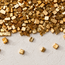 Stone mosaic detail: small gold tile squares clustered over a white textured backing.
