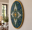 Oval blue-green stone mosaic wall art with white flower rays, orange center, and gold edge
