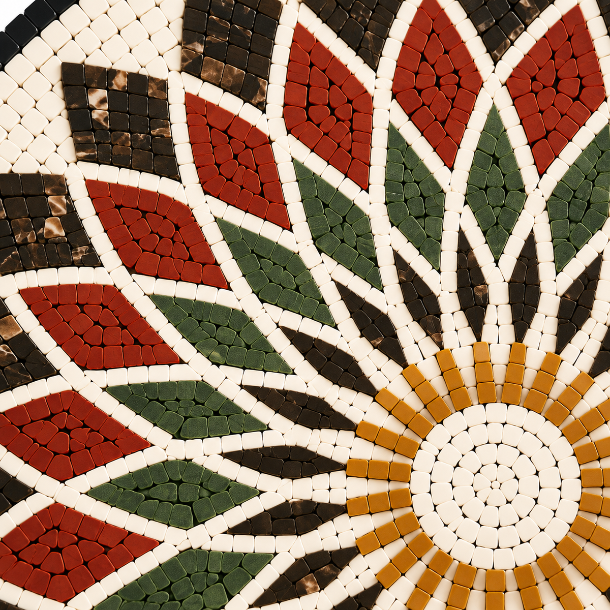Close-up stone mosaic wall art with red petals, green leaves, and gold center