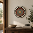 Round stone mosaic wall art with red, green, and cream floral design and gold center