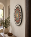 Handmade stone mosaic wall art with red, green, and cream floral pattern on round frame