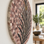 Round palm stone mosaic wall art, close-up of multicolor tile rays