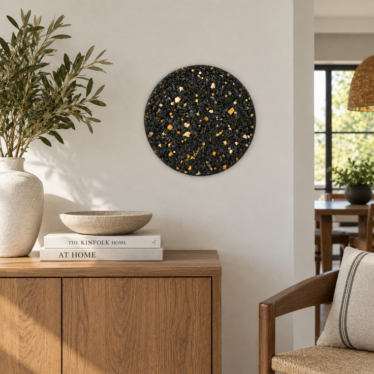 Round handmade stone mosaic wall art with black stone pieces and gold highlights