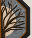 Close-up octagonal stone mosaic wall art of branching tree design in blue-gray and tan
