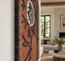 Stone mosaic wall art with orange arch, black branches, and a white moon circle
