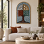 Arched stone mosaic wall art featuring tree motif with multicolor tiles in an interior setting