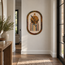 Handmade stone mosaic wall art with arched top, reed-and-vase motif in gold, green, and dark