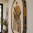 Handmade stone mosaic wall art with arched frame and reed stems in gold and dark tones