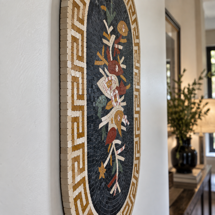 Oval floral mosaic wall hanging with Greek key border and black background.