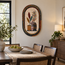 Oval stone mosaic wall art showing potted plants and vases in arched border