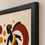 Mosaic wall art corner with black frame and red-and-black dancer tiles