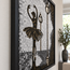 Close-up of framed monochrome glass mosaic ballerina and hanging lamp shapes