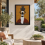 Framed mosaic wall panel showing water bearer figure with jug, warm yellow tile background