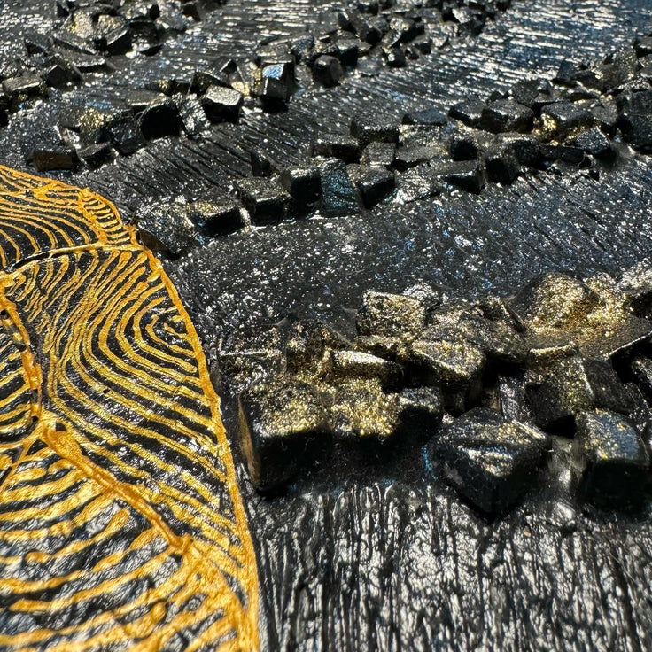 Two-panel mosaic wall art, close-up of gold and dark gray tile rays in an eclipse pattern