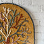 Close-up of arched tree mosaic panel with small glass tile pieces and multicolor trunk