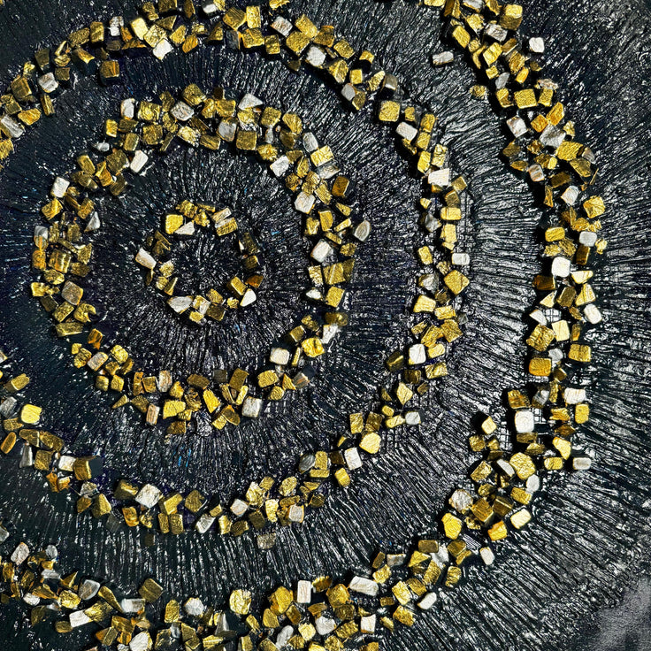 Framed golden spiral mosaic with concentric circles on dark textured background.
